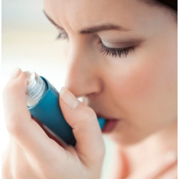 Woman taking asthma Inhaler